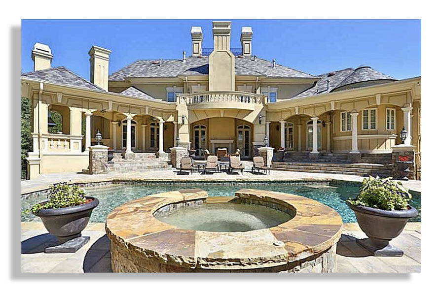 a pool in the foreground, in the background is the back of a mansion